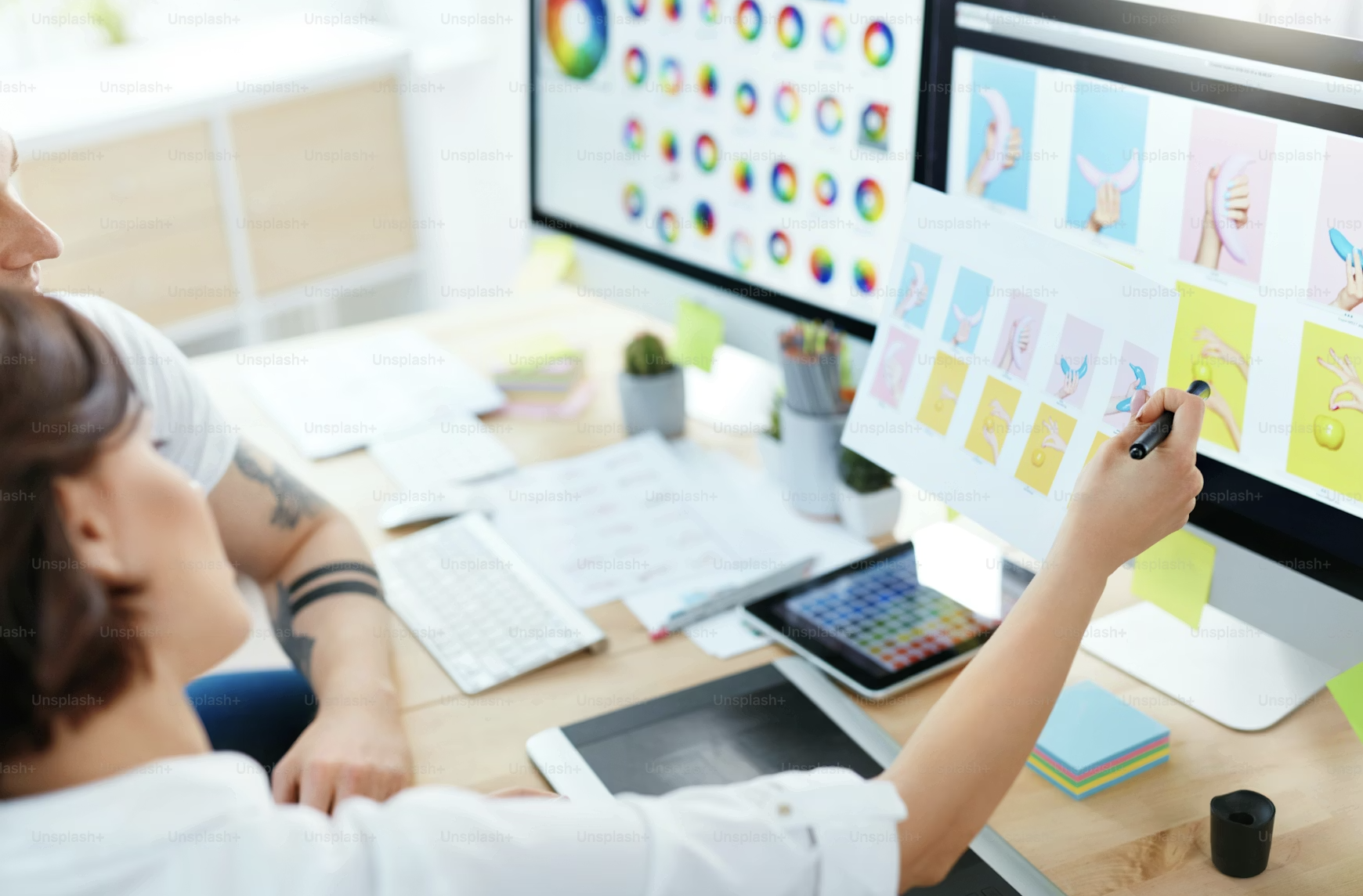 Designers reviewing brand work on screen